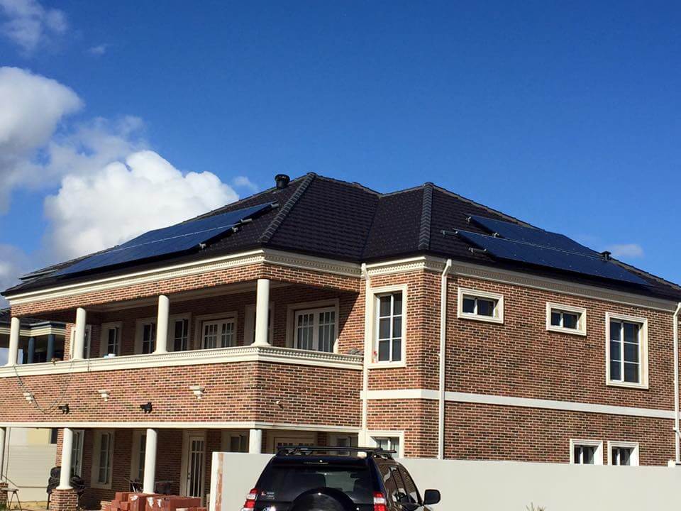 solar panels atop brick house